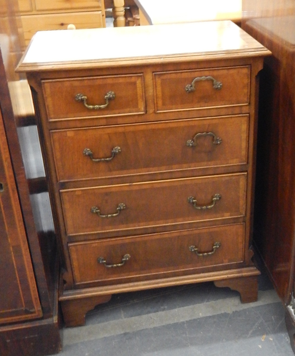 Reproduction mahogany small chest of two short and three long drawers, on bracket feet,