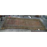 Eastern wool runner with stylised flowerhead trelliswork to the madder field, multiple borders,