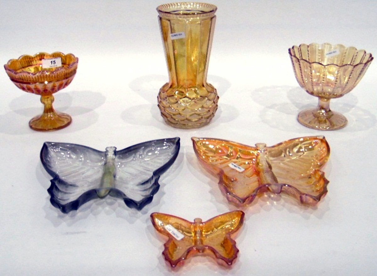 Two carnival glass butterfly dishes, one marigold and one green,
