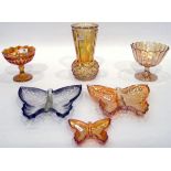 Two carnival glass butterfly dishes, one marigold and one green,