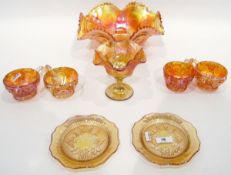 Large marigold carnival glass punch bowl with wavy rim and with six matching cups,