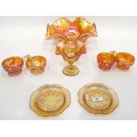 Large marigold carnival glass punch bowl with wavy rim and with six matching cups,