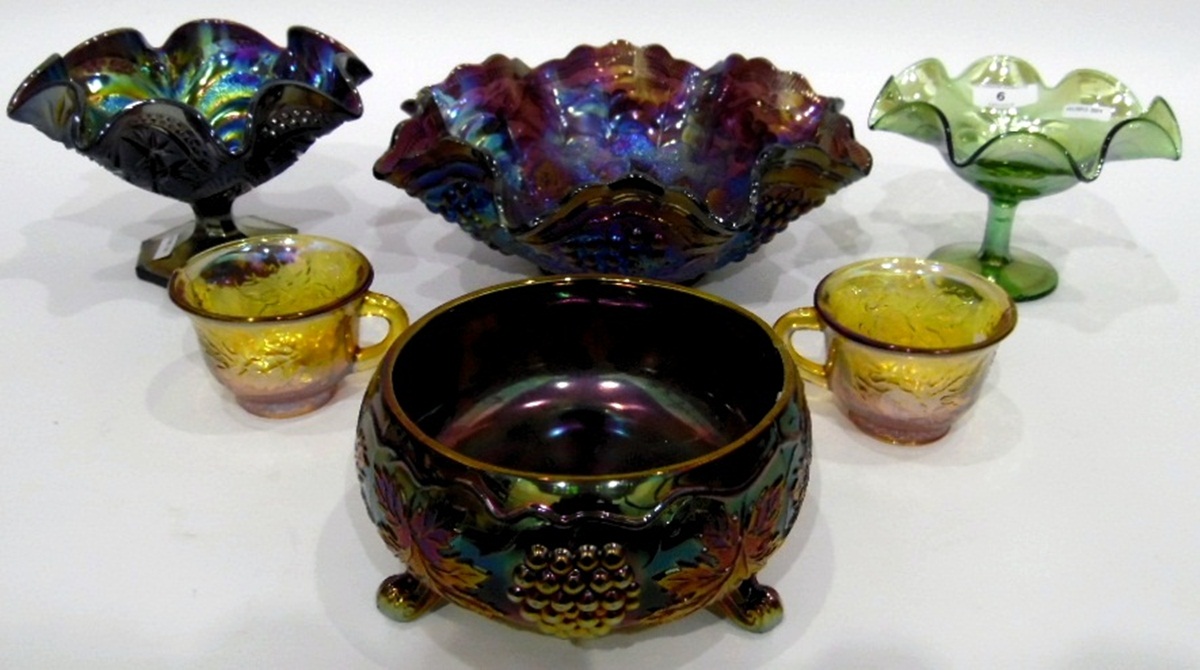 Large carnival glass punch bowl and cups decorated with fruiting vines,