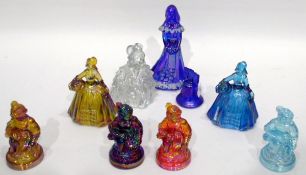 Quantity of carnival glass ornaments including four figures of seated girls in different colours,