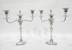 Pair of Georgian style silver plate two-light candelabra of typical form.
