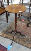 George III mahogany lamp table with circular top over turned stem and tripod base,