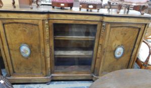 Victorian walnut credenza with central glazed door revealing shelves,