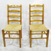 Three modern pine kitchen chairs with ladder backs and rush seats