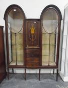Edwardian mahogany display cabinet, the central cupboard with inlaid urn decoration,
