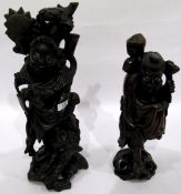 Chinese carved hardwood figure of a man with a chained dog at his feet,
