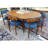 Mid 20th century G-Plan extending dining table of oval form with a set of six dining chairs