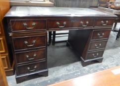 Mahogany pedestal desk, the top with tooled leather inset,