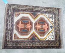 Baluchi wool rug having two octagonal guls, on an ivory field and four geometric borders,