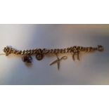 Gold (possibly 18ct) charm bracelet, curb link pattern hung with several charms,