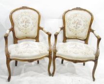 Pair of Louis XVI-style French open elbow chairs with carved cresting rails, cabriole legs,