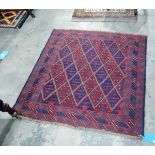 Tribal Kazak wool rug with red and blue lozenge trelliswork to the field, with geometric motifs,
