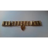 9ct gold gate-pattern bracelet and the 9ct gold heart-shaped padlock clasp,