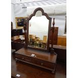 Mahogany shaped swing frame mirror above two drawers, on bun feet,