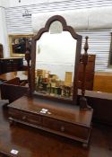 Mahogany shaped swing frame mirror above two drawers, on bun feet,