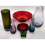 Modern red glass bowl of circular form, on shallow pedestal foot, with a spiral trailing decoration,