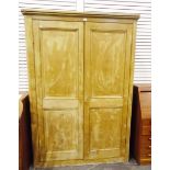Pine two-door cupboard, the two panel doors revealing interior shelves,