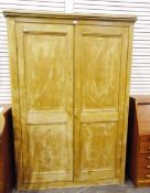 Pine two-door cupboard, the two panel doors revealing interior shelves,