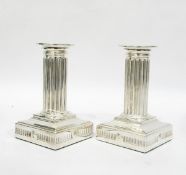 Pair of silver plated candlesticks, of squat form with beaded rim, fluted column,