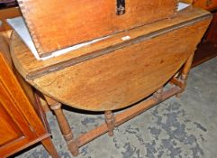 Old oak oval-top gateleg table with moulded edge, on turned baluster supports,