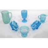 Quantity of blue pressed glass including a pair of baskets with opalescent rims, various jugs,