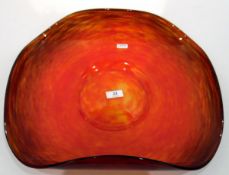 Shallow glass bowl of folded circular form, the body in mottled red and brown,