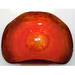 Shallow glass bowl of folded circular form, the body in mottled red and brown,