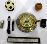 Modern barometer modelled as a porthole, a quantity of football trophies,