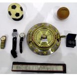 Modern barometer modelled as a porthole, a quantity of football trophies,