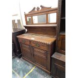 Edwardian oak mirror-back sideboard with carved cresting rail over three bevelled mirror plates,