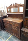 Edwardian oak mirror-back sideboard with carved cresting rail over three bevelled mirror plates,