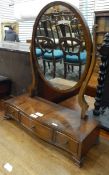 Reproduction mahogany oval toilet mirror of three drawers, on bracket feet,