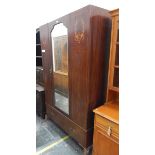 Edwardian mahogany wardrobe with inlaid decoration and central mirror door,