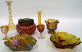 Quantity of carnival glass including three bowls decorated with leaves and berries,