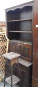 Oak bookcase fitted with three open shelves, with cupboards and drawers under,