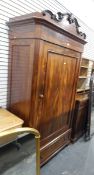 Victorian mahogany wardrobe with scrolling cornice over a single panelled door,