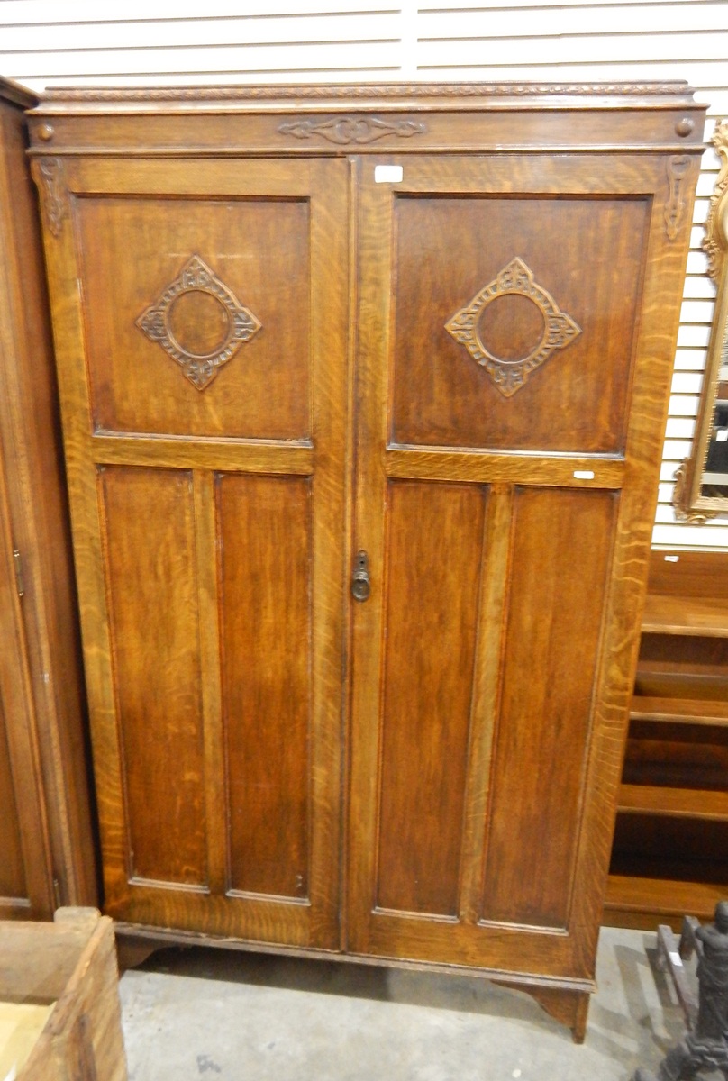 Early to mid 20th century oak two-door wardrobe with carved decoration,