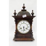 Oak cased mantel clock with three turned finials to the domed top, white enamel dial,