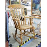 Modern high back Windsor rocking chair with outswept arms