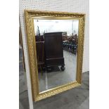 Modern rectangular gilt framed mirror, the mirror with bevelled edge, floral detail to frame,
