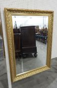 Modern rectangular gilt framed mirror, the mirror with bevelled edge, floral detail to frame,