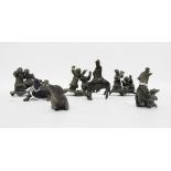 Three Japanese small bronze-effect metal model figure groups including groups of boys playing,