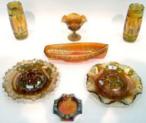 Large quantity of marigold carnival glass including a pair of vases with geometric decoration,