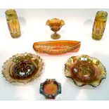 Large quantity of marigold carnival glass including a pair of vases with geometric decoration,