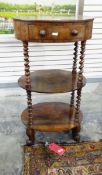 Victorian rosewood three-tier whatnot occasional table of oval form,