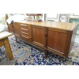 Mid 20th century G-Plan-style teak sideboard fitted with four central drawers flanked by cupboards,